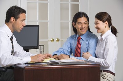 Jupiterimages/Creatas/Getty Images A new title search is part of the refinance process.