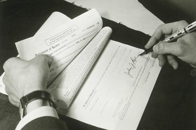 FPG/Retrofile/Getty Images Both parties should sign the flat rental document.