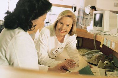 Comstock/Comstock/Getty Images Professional certification such as the CMAA can improve earnings.