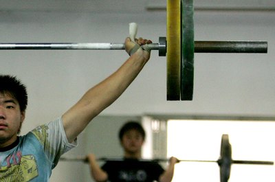 Guang Niu/Getty Images News/Getty Images The overhead press is part of a CrossFit Total workout.