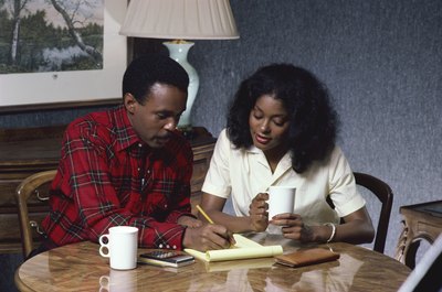 Jupiterimages/Photos.com/Getty Images Couples should work on a budget together to establish a strong financial partnership.