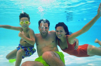 Stockbyte/Stockbyte/Getty Images Check a pool's pH before opening your eyes underwater.