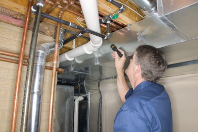 Jupiterimages/liquidlibrary/Getty Images Code enforcement officers conduct inspections.