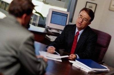 Keith Brofsky/Photodisc/Getty Images Management accountants help businesses manage risk and investments.