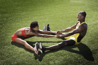 Jupiterimages/Brand X Pictures/Getty Images Assisted stretching means stretching with a partner.