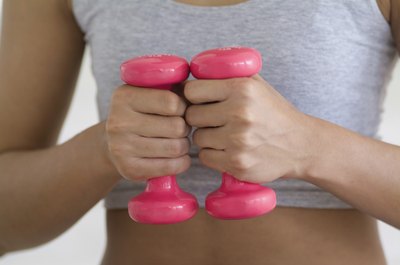 Medioimages/Photodisc/Photodisc/Getty Images 5-pound dumbbells can stow easily in your suitcase for out-of-town trips.