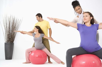 Jupiterimages/BananaStock/Getty Images Pregnant women can reduce hip and back pain with stability ball workouts.