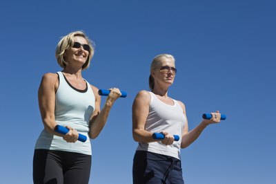 Jupiterimages/Goodshoot/Getty Images Walking with light weights is appropriate for women of all ages.
