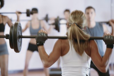 Comstock/Comstock/Getty Images The barbell military press works many upper body muscles.