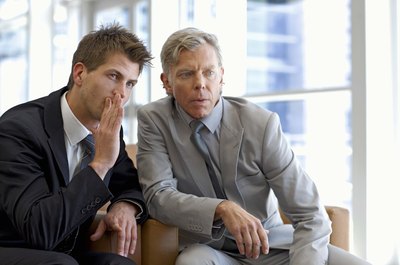 Jupiterimages/Goodshoot/Getty Images Remain professional when dealing with a back-stabbing co-worker.