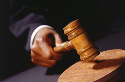 Photodisc/Photodisc/Getty Images Buying a home at auction can help you to find a bargain property.