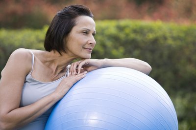 Jupiterimages/Creatas/Getty Images Incorporating fitness ball exercises can help you lose weight more quickly.