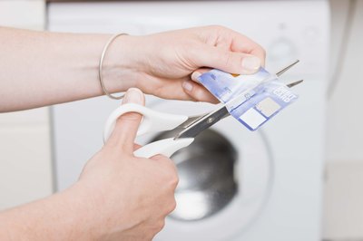 Jupiterimages/Polka Dot/Getty Images Cut up credit cards to keep from using open lines of credit.