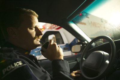 Thinkstock Images/Comstock/Getty Images A police officer prepares to go on patrol.