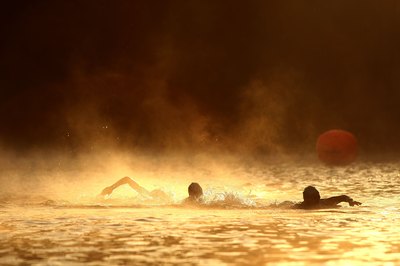 Ezra Shaw/Getty Images Sport/Getty Images Swimmers cross the Russian River during a half Ironman in Northern California.