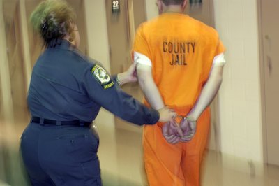 Thinkstock Images/Comstock/Getty Images Correctional officers often work with prisoners much larger than them.