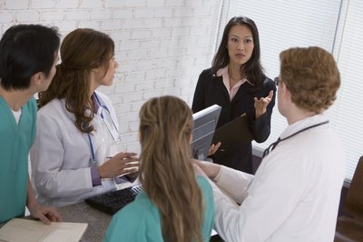 Comstock Images/Comstock/Getty Images Medical managers typically work in hospitals and other large medical centers.