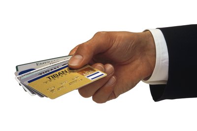 Comstock/Comstock/Getty Images Credit cards have grown from a status symbol for a chosen few to being part of most American households.