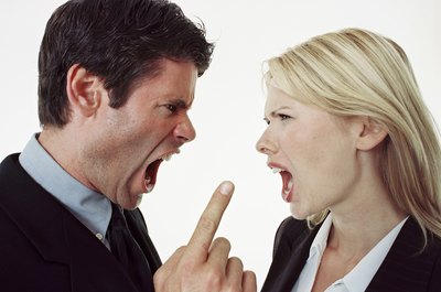 BananaStock/BananaStock/Getty Images Handling moody behavior in the workplace is key to building a positive work atmosphere.