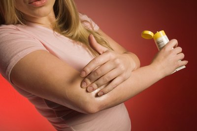 Creatas Images/Creatas/Getty Images A sore elbow may be the result of playing with a stiff racket.