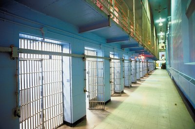 Jupiterimages/Photos.com/Getty Images Prison teachers provide education to inmates.