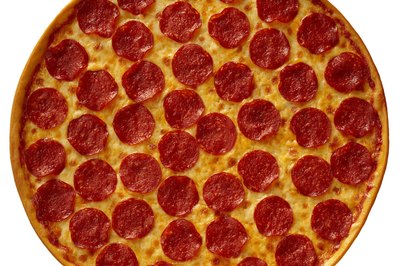 Brand X Pictures/Brand X Pictures/Getty Images Cut fat and calories by substituting veggies and low-fat meats for pepperoni on your pizza.