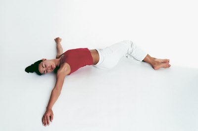 Polka Dot Images/Polka Dot/Getty Images Reclining Twist is a gentle movement to relieve back pain.