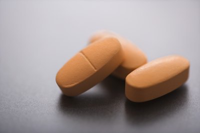 Thinkstock/Comstock/Getty Images Taking a multivitamin helps boost your B-12 intake.