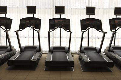Jupiterimages/Comstock/Getty Images Toning your legs starts with turning on a treadmill.