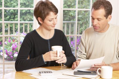Hemera Technologies/AbleStock.com/Getty Images A secondary signer on an account should review bank rules.