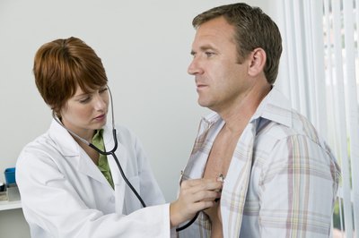 Jupiterimages/Goodshoot/Getty Images Pulmonologists use a stethoscope to listen to the heart and lungs.