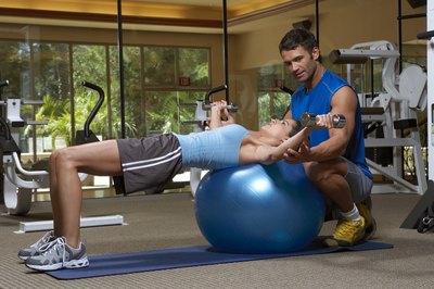 Chris Clinton/Digital Vision/Getty Images Chest flies are more challenging when done on a stability ball.