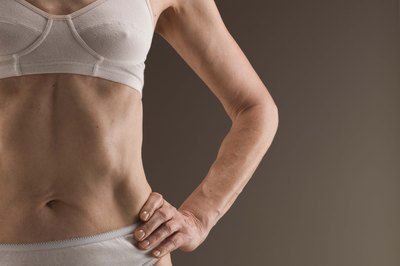 Jupiterimages/Polka Dot/Getty Images Bust that side fat with a multipronged approach.