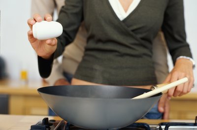 George Doyle/Stockbyte/Getty Images To reduce your salt intake, replace it with other seasonings when you cook meals.