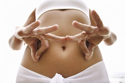 Thinkstock/Comstock/Getty Images Yoga fights belly fat by combating stress.