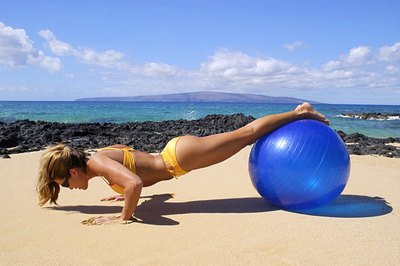Thinkstock/Comstock/Getty Images Incorporating fitness ball exercises into your workout can strengthen your core muscles.