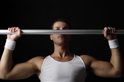 Jupiterimages/Goodshoot/Getty Images Pronated-grip pull-ups position your hands so that palms are facing away from you.