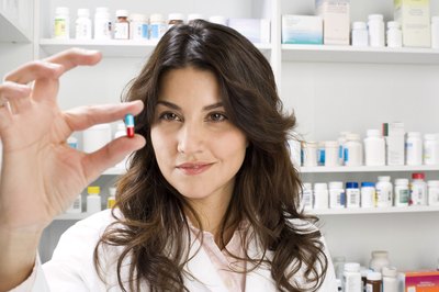 Jupiterimages/Comstock/Getty Images Pharmacy technicians fill prescriptions for the pharmacist.