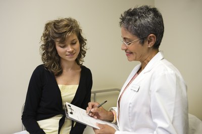 Jupiterimages/Comstock/Getty Images Plastic surgeons conduct plastic and cosmetic surgeries on patients.