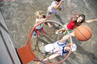 Goodshoot/Goodshoot/Getty Images Playing basketball can improve your health in many ways.