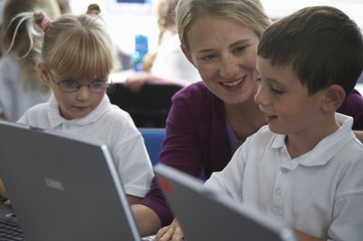 Ableimages/Photodisc/Getty Images Computer lab teacher aides assist both students and teachers in the lab.
