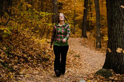 Jupiterimages/Photos.com/Getty Images Hiking on a natural surface trail in the woods can offer a mental escape.