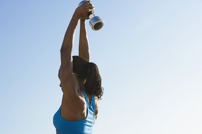 Brand X Pictures/Brand X Pictures/Getty Images Hit the triceps with overhead triceps extension.
