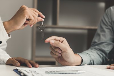 How Do I Transfer Real Estate Property Into Someone Else's Name?