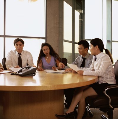 Creatas/Creatas/Getty Images Putting an end to gossiping in the workplace will help build trust among co-workers.