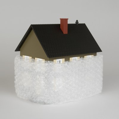 Jupiterimages/Comstock/Getty Images Insulating your house saves energy and might mean a lower tax bill.