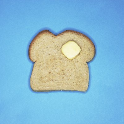 Burke/Triolo Productions/Brand X Pictures/Getty Images That butter could have as many calories as the slice of bread.