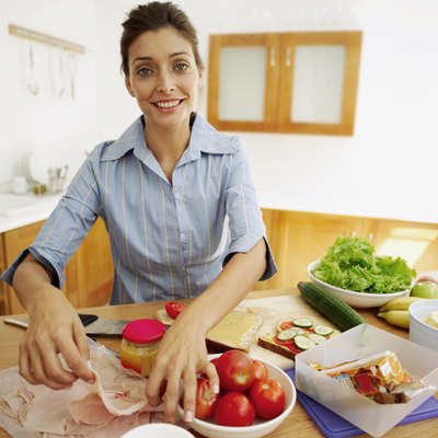 George Doyle/Stockbyte/Getty Images Avoid excess calories by using less deli ham on sandwiches.
