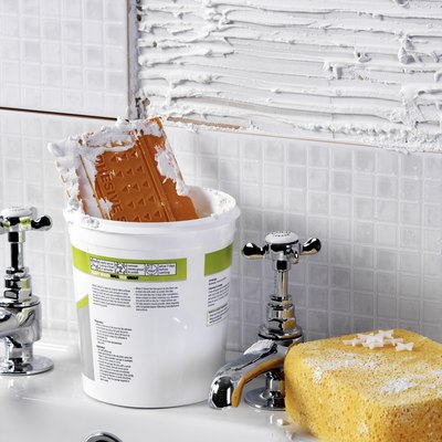 Polka Dot Images/Polka Dot/Getty Images Adding tile can update your bathroom on a budget.