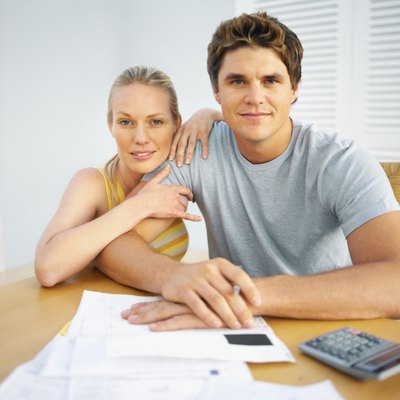 Stockbyte/Stockbyte/Getty Images Run through your monthly outgoings with your partner.